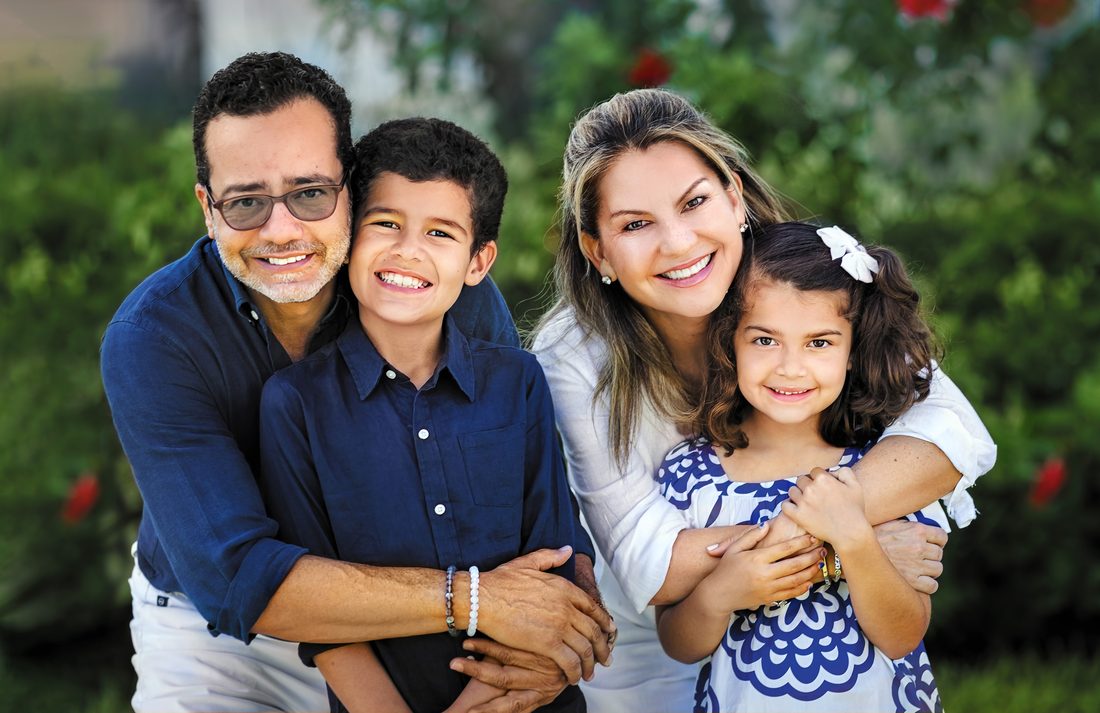 Portrait of parents and their two children in a garden