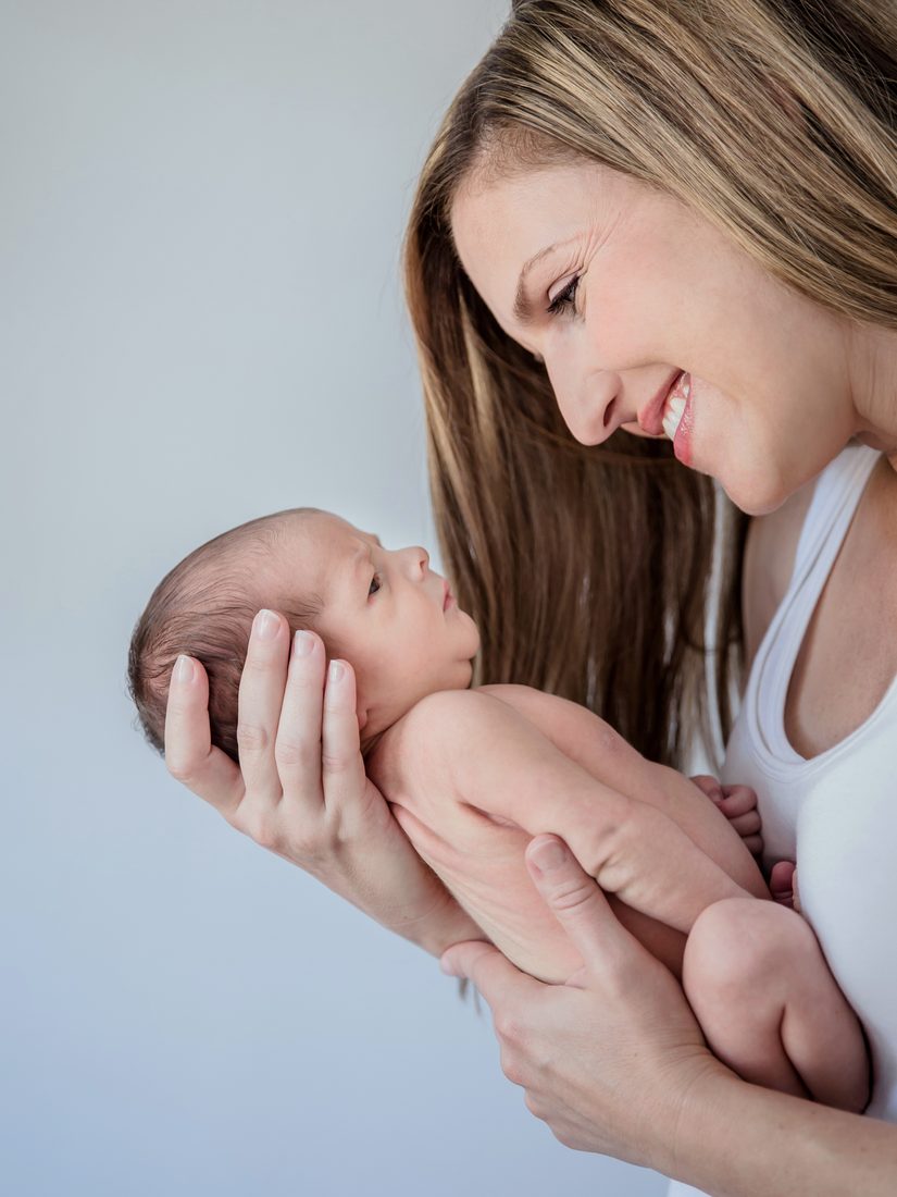 Close-up of a mother holding her newborn baby