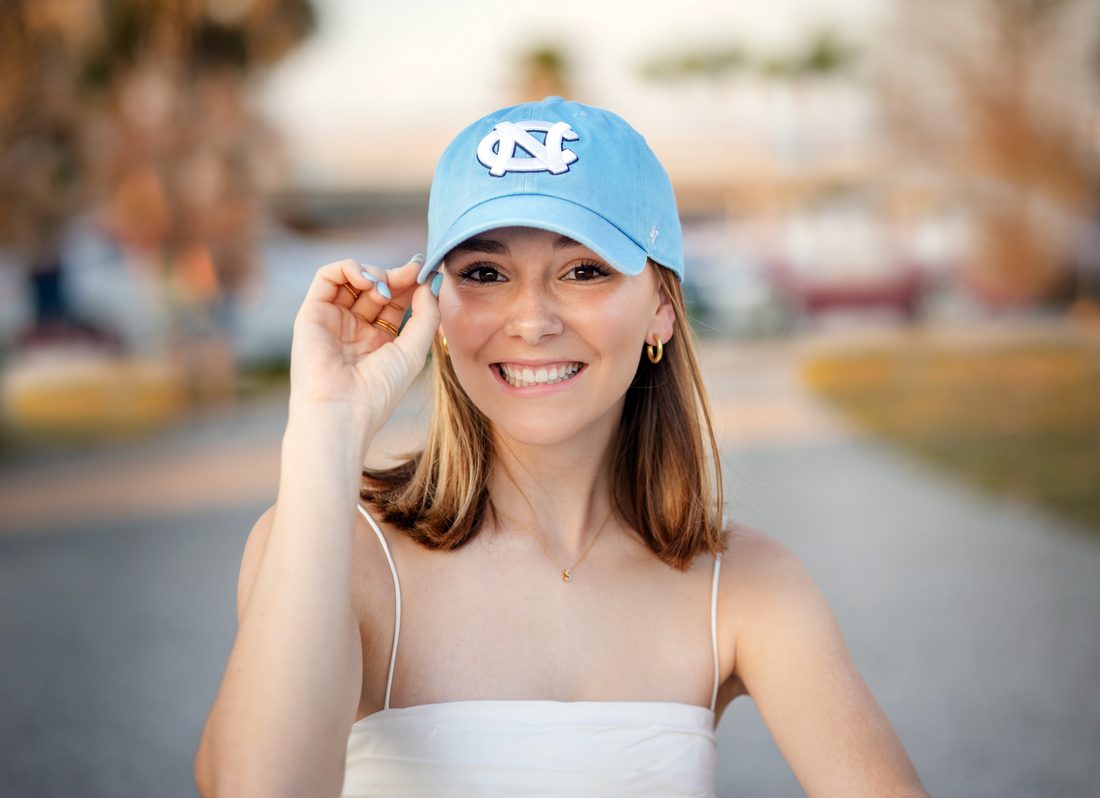 Senior portrait in a UNC ballcap