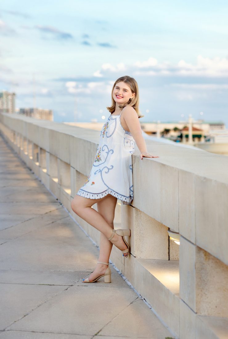 Senior portrait on a waterfront pier at golden hour